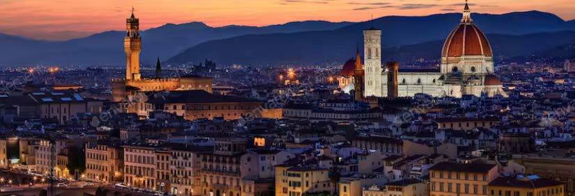 The Duomo and Palazzo Vecchio and the city of Florence at night.