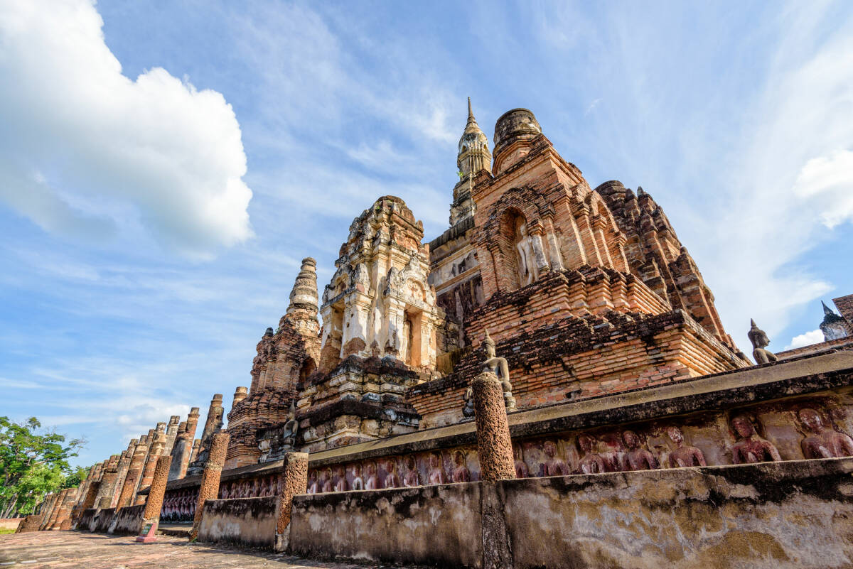 Ancient brick chapel under the blue sky in Sukhothai Historical Park of Sukhothai Province, Thailand.