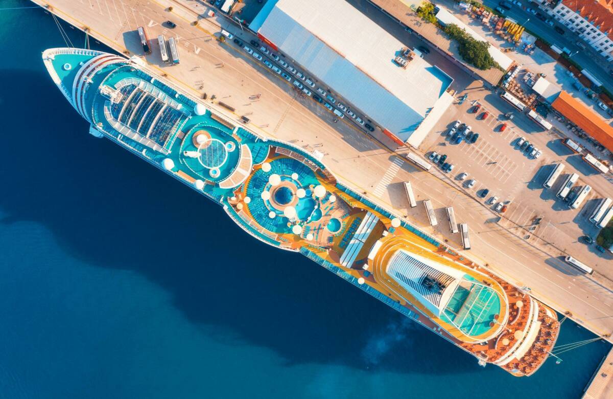 Aerial view of swimming pool, sunbeds, and umbrellas on the cruise ship.