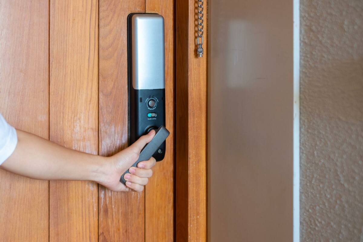 holding handle of smart digital door lock on an airbnb rental.