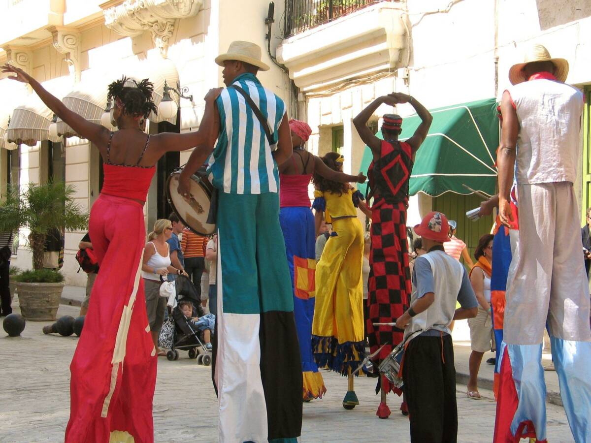 Colorful dancers and stilt walkers celebrate at the lively Santiago de Cuba Carnival.