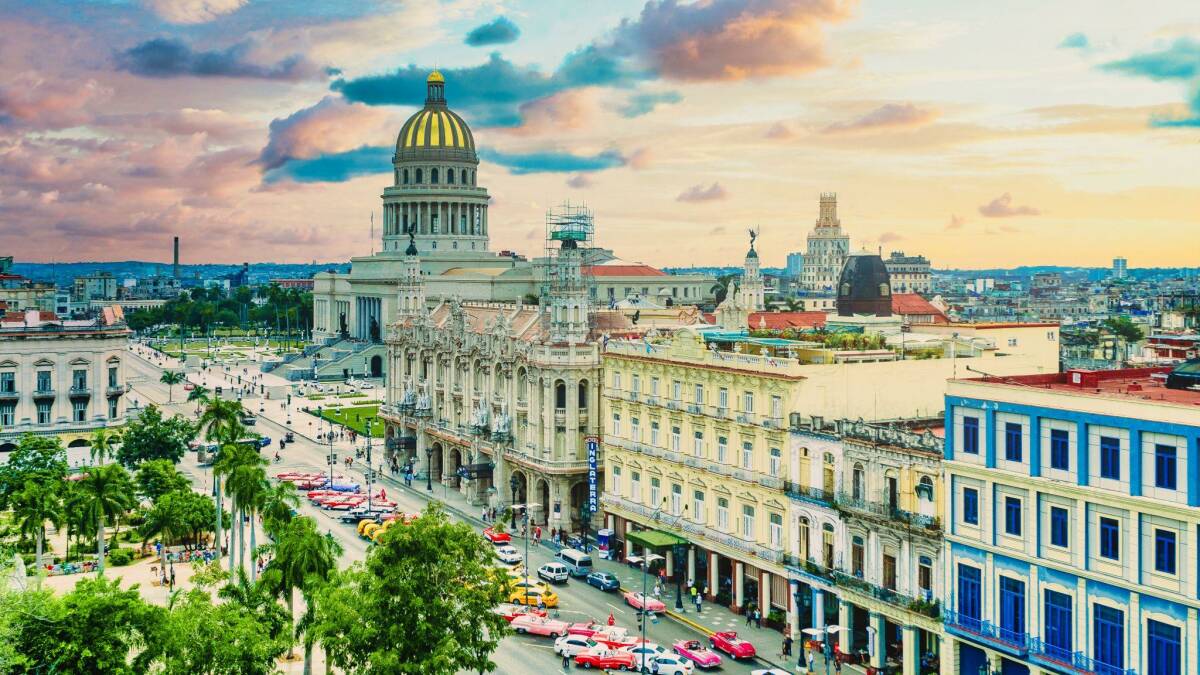 Historic Havana Cuba's bustling city streets, featuring the iconic Capitol building at dusk.