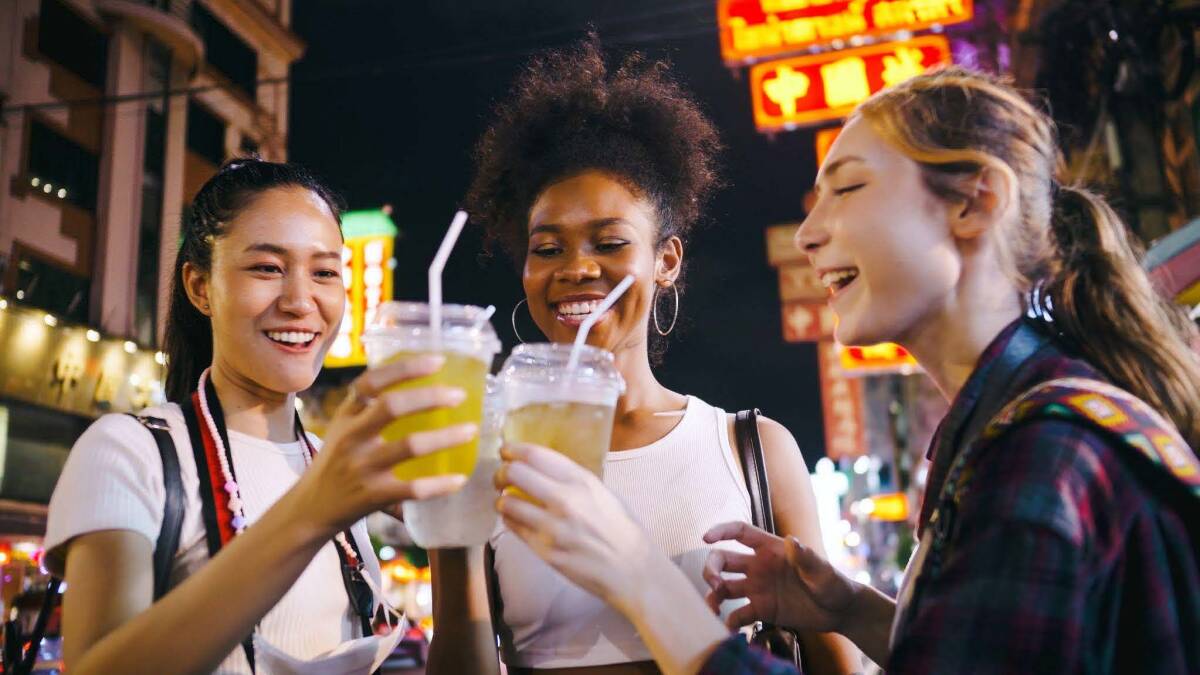 A group of friends enjoying a night out in Chinatown in Bangkok, Thailand.