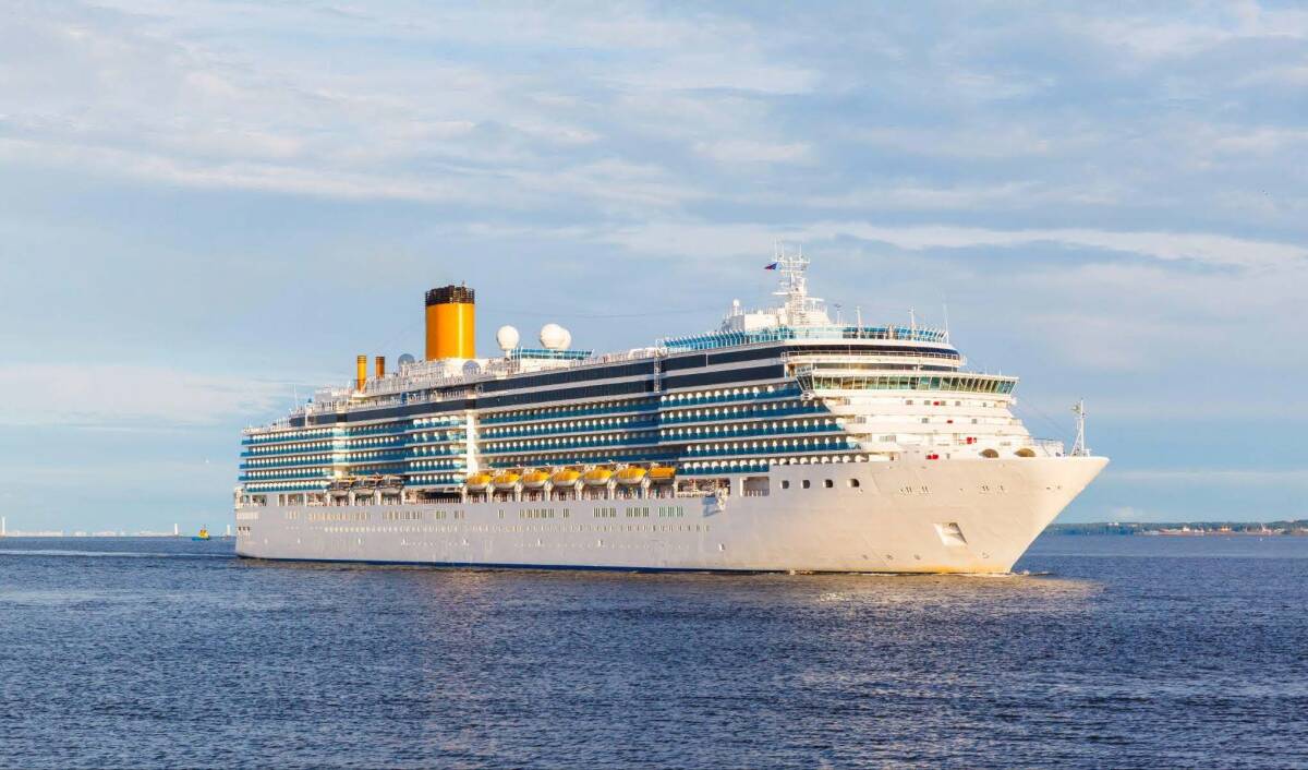 A large Royal Caribbean cruise ship sailing across the ocean.