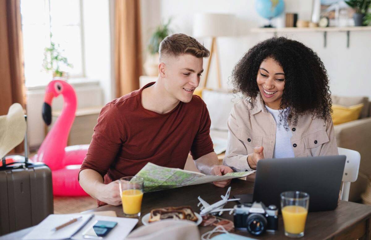 Couple happily preparing for their vacation, emphasizing the importance of having good travel insurance for a hassle-free adventure.