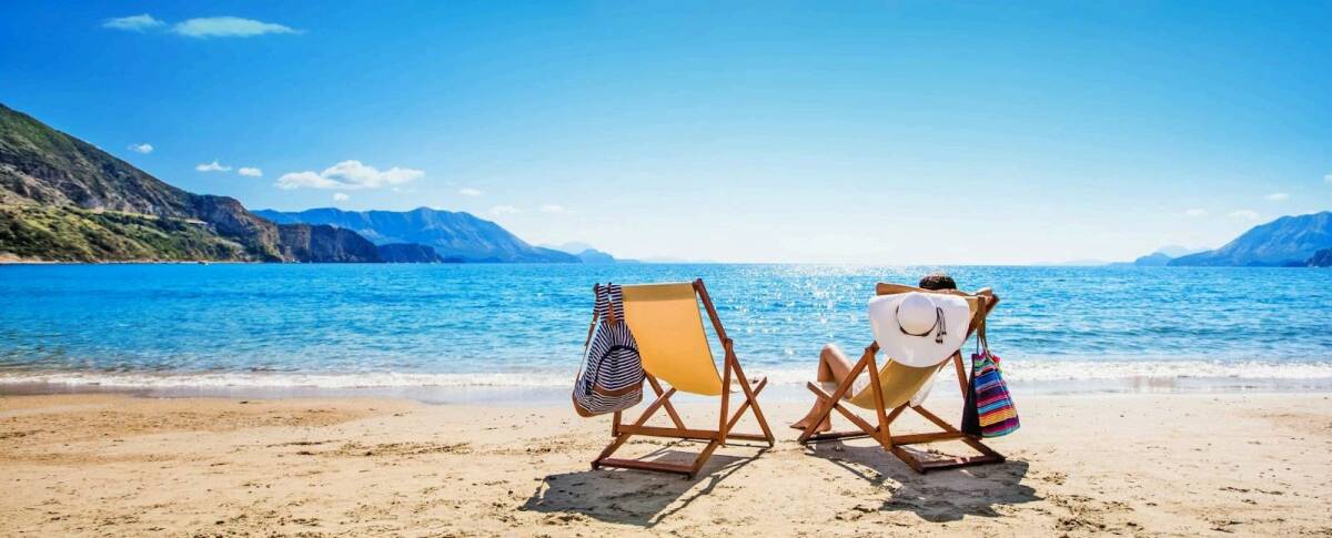 Woman on beach enjoying her summer trip